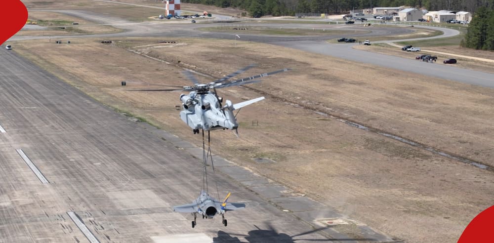 Helicopter refueling military jet mid-air