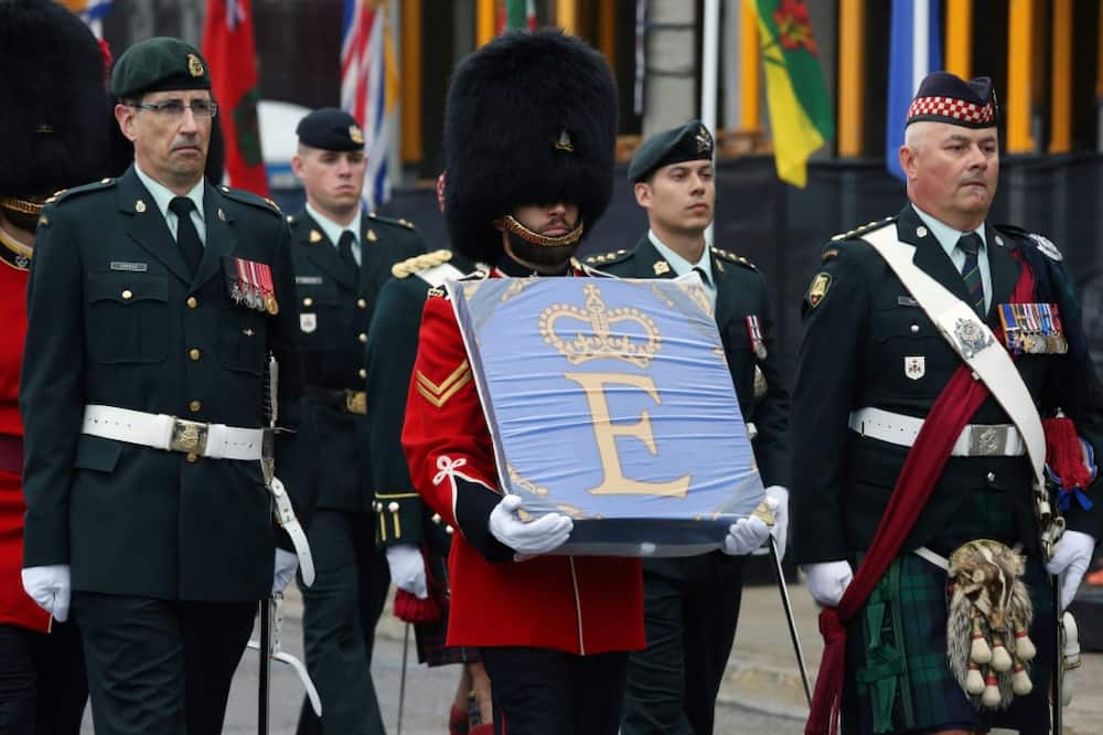 A member of the Governor General's Foot Guards carries the Queen Elizabeth Canadian flag during a memorial service for Queen Elizabeth II in Ottawa, Canada on Monday