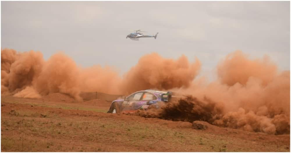 Man on Top of Pickup Hands out Condoms in Naivasha Safari Rally.