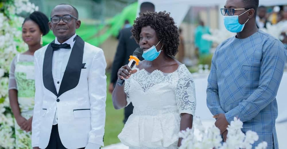 Mother advises daughter at wedding.
