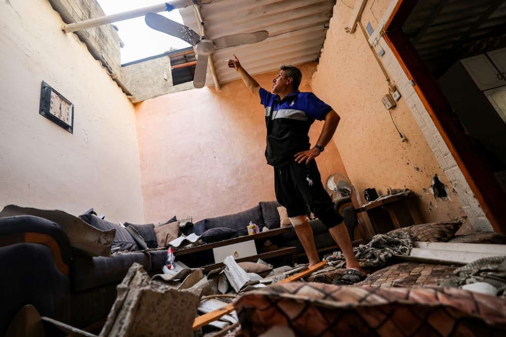 A man inspects damage to a house affected by an Israeli air strike at the Jabalia camp for Palestinian refugees in the northern Gaza Strip on August 6, 2022