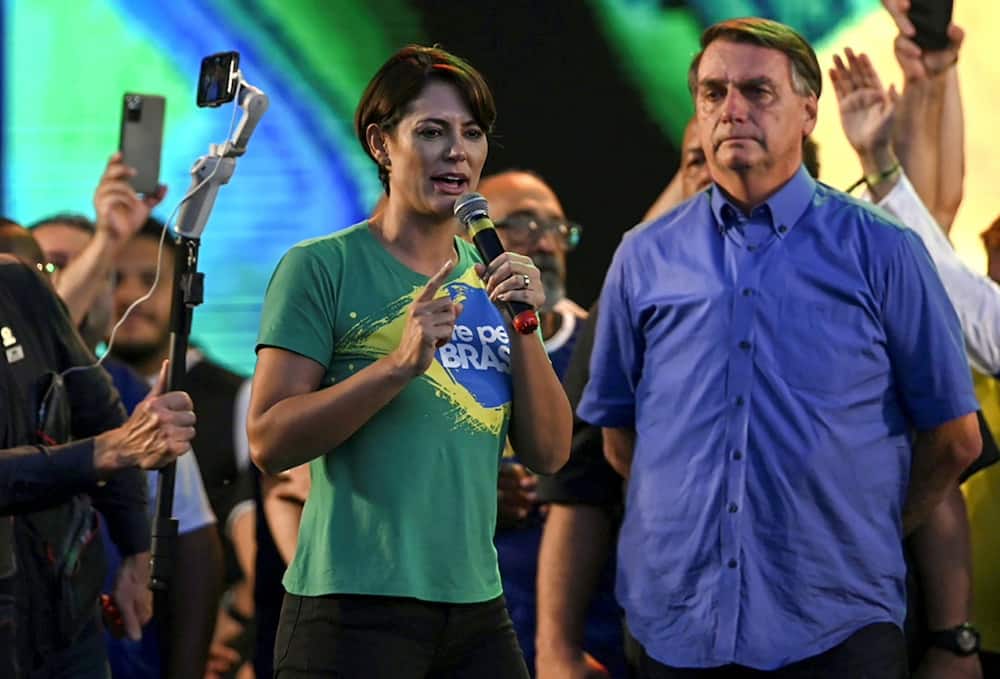 President Bolsonaro listens to his wife Michelle Bolsonaro during the March for Jesus Christ event in Rio de Janeiro, Brazil