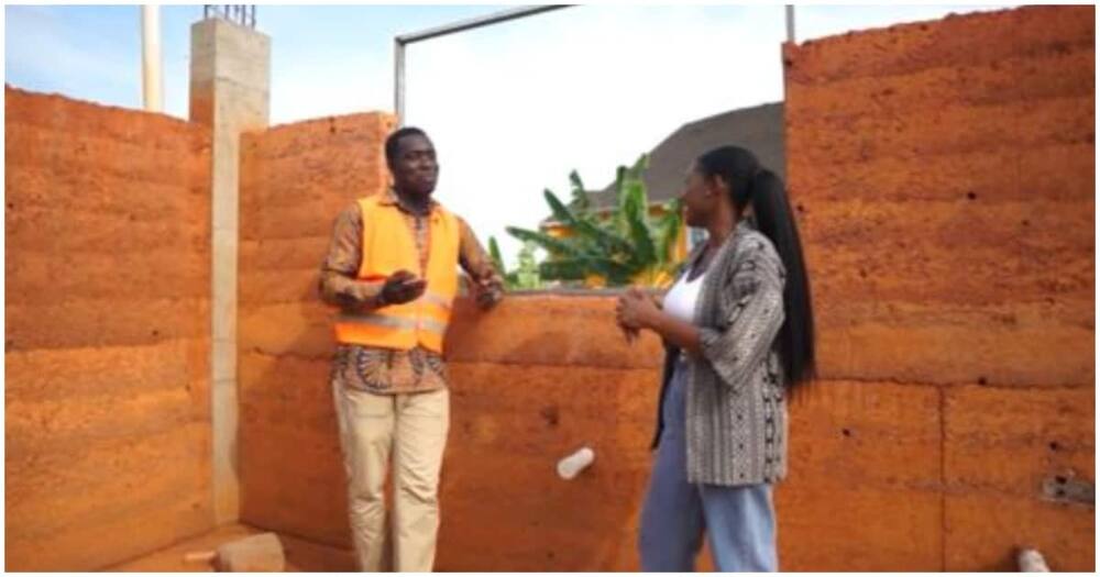 Mr Appau speaks with an interviewee about his rammed earth building projects