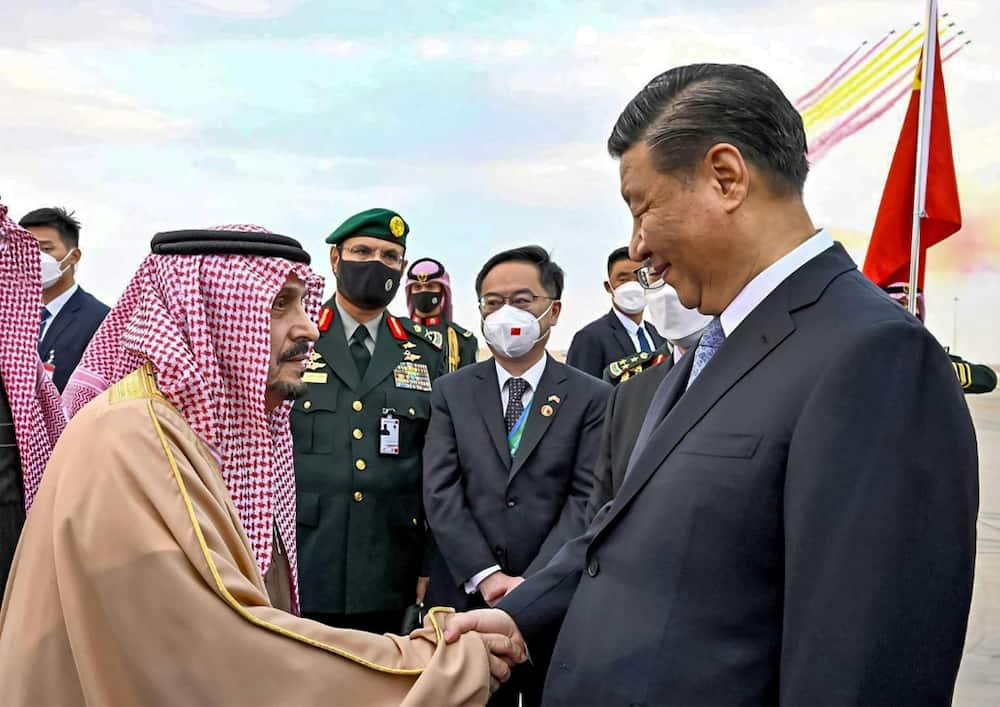 China's President Xi Jinping is greeted on arrival in Saudi Arabia by Riyadh province governor Prince Faisal bin Bandar al-Saud