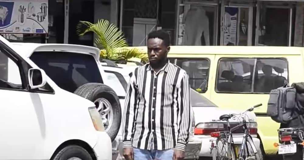 Man standing on busy road.