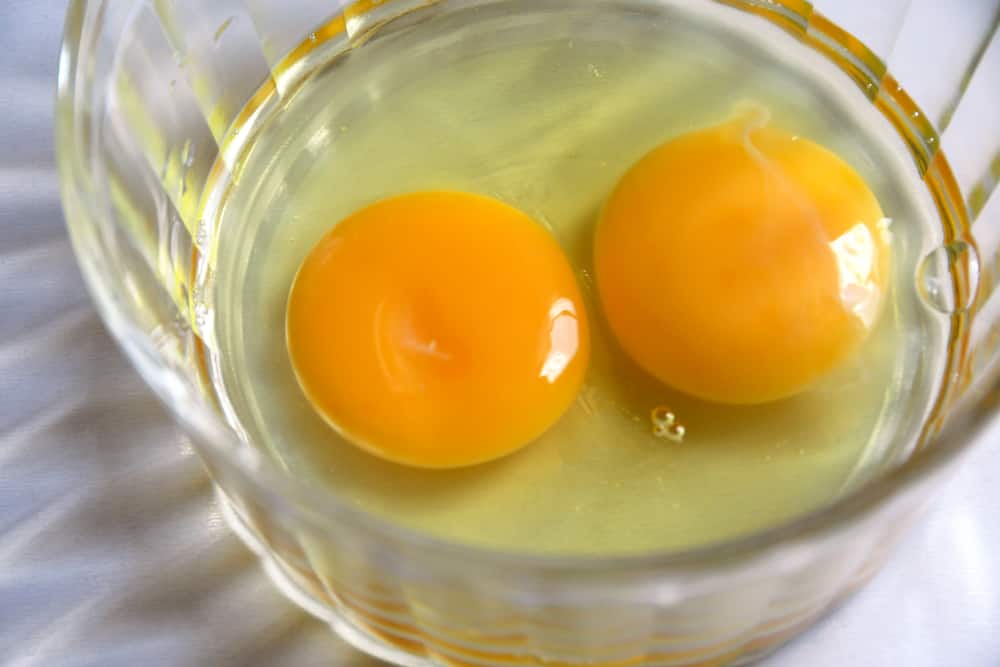 Two raw eggs in bowl
