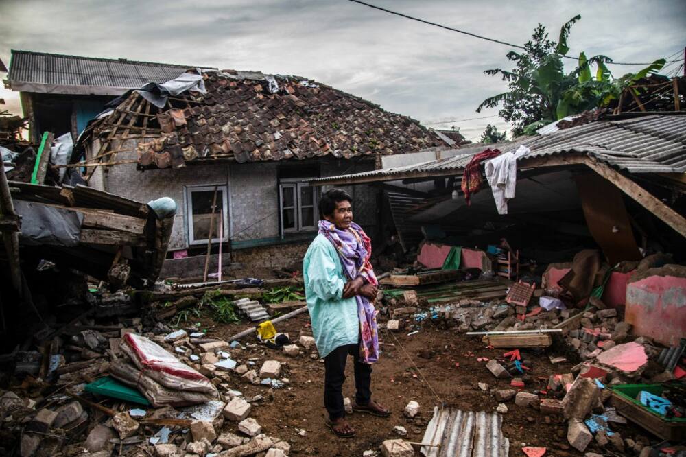 A villager looks at damaged houses following a 5.6-magnitude earthquake that killed at least 162 people in West Java
