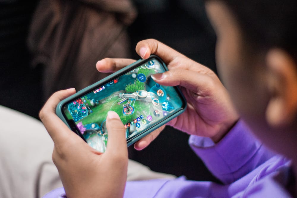 A person playing games on her phone.