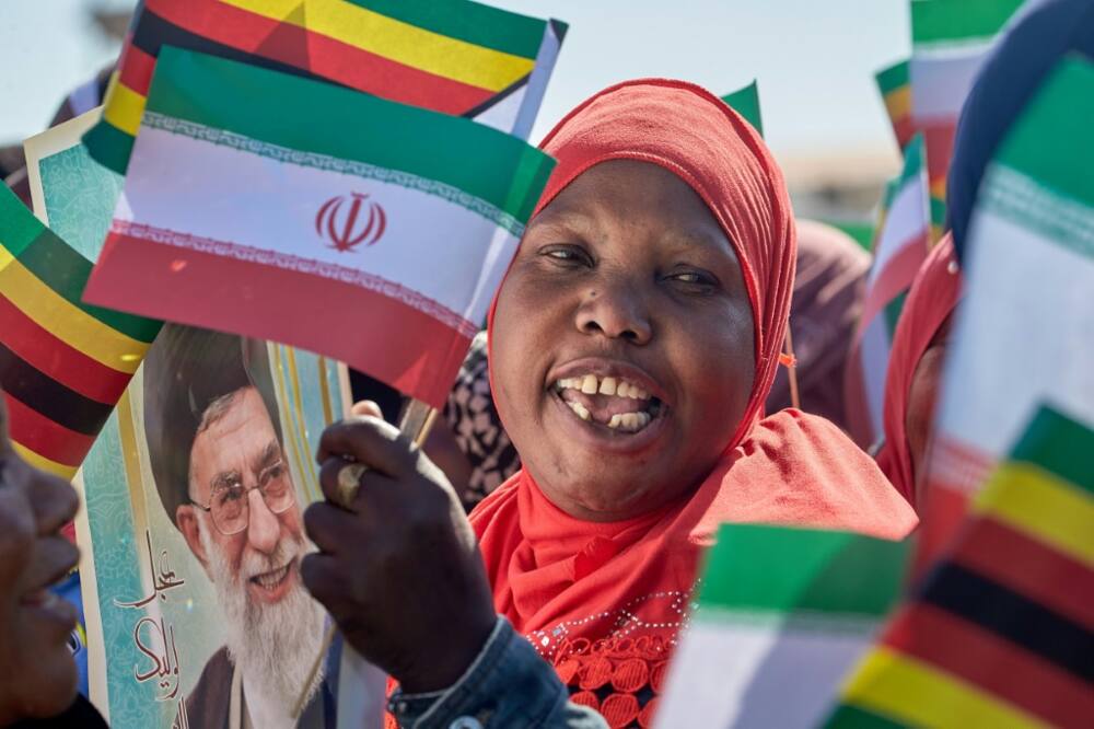 Hundreds of people waving Zimbabwean and Iranian flags gathered at Harare international airport to welcome President Raisi