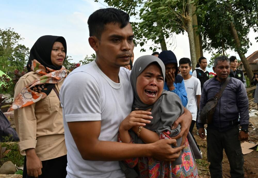 An Indonesian family bids goodbye to a father of four killed in a powerful quake