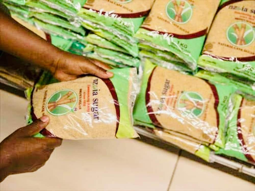 A customer picking Nzoia Sugar from the supermarket shelf.