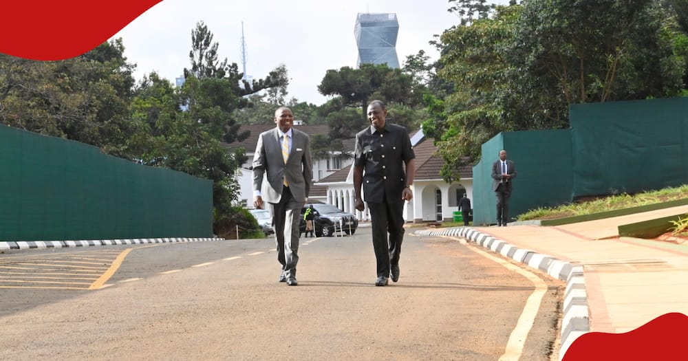 President William Ruto walks with Kimani Ichung'wah at state house with Prism Towers in the background.