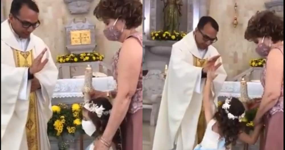 Young girl hilariously misreads priest's hand of blessing for a high five