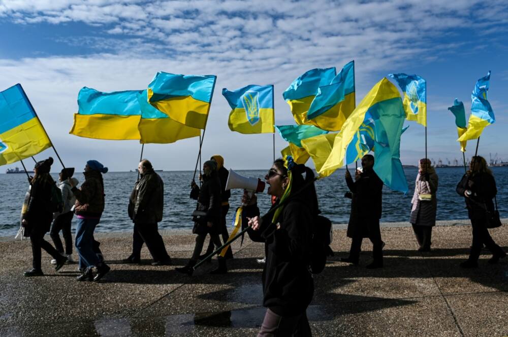 Ukrainians living in Greece wave Ukrainian flags during a demonstration in Thessaloniki on January 21, 2024
