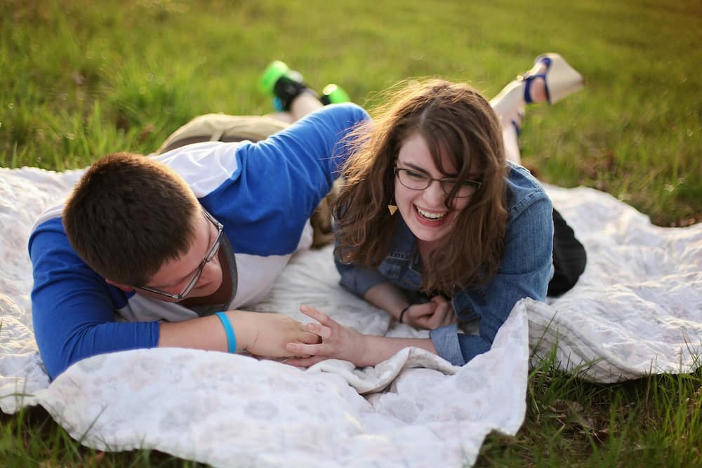 A couple lying on a mat and having fun