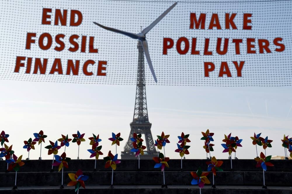 Activists demonstrated against fossil fuel finance in central Paris on the eve of the summit
