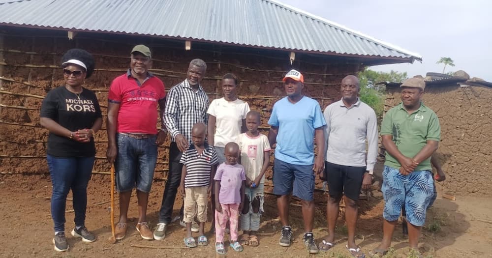 Otiende Amollo (third right) has been needy families build decent houses.