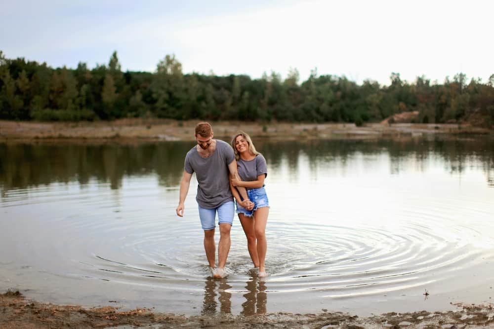 A couple happily walking in water