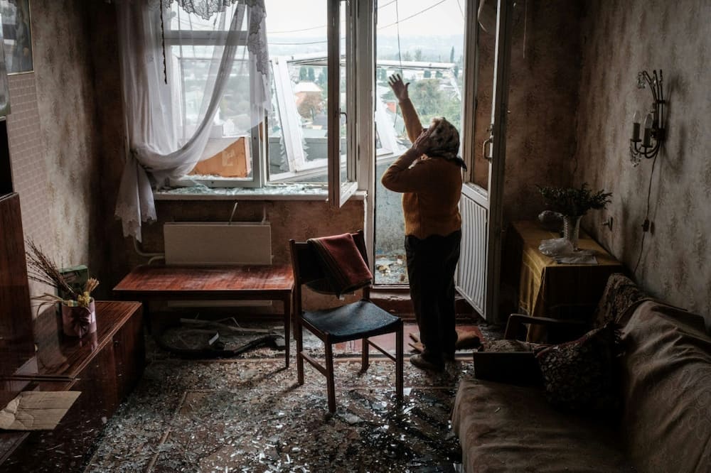 Lyubov Prokopivna in her damaged building, hit by a missile in Kharkiv on Wednesday