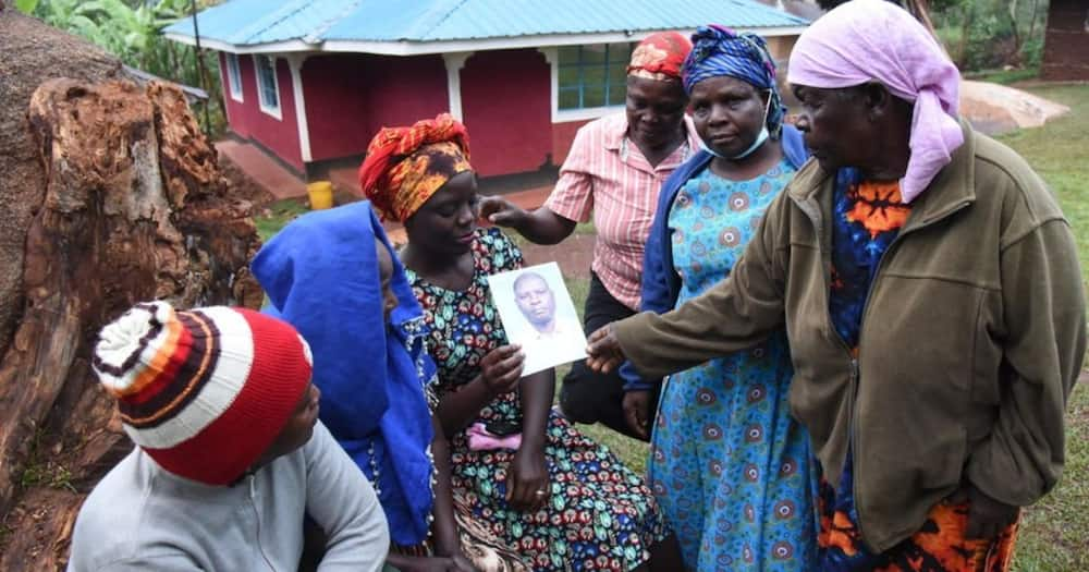 Family members and friends of the late John Atsiaya (pictured in photo held). Photo: Nation.