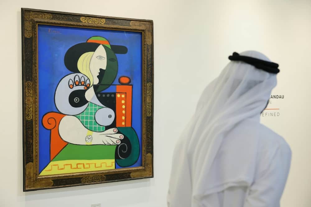A visitor looks at Pablo Picasso's painting 'Femme a la montre' displayed for viewing at Sotheby’s Dubai, ahead of an auction in New York