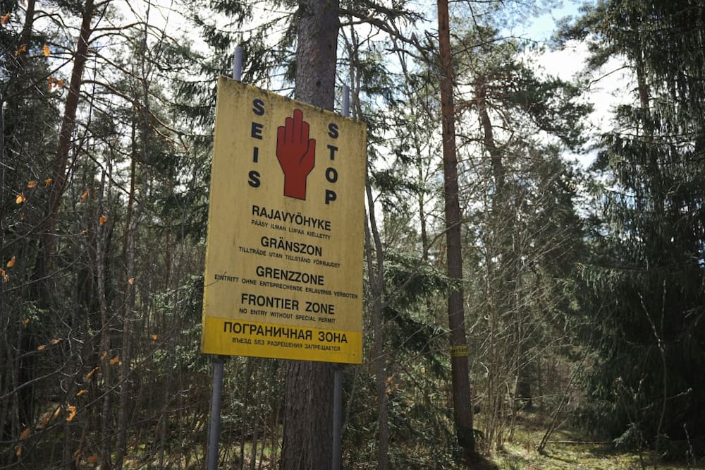 A sign reads 'Stop, border area' in a forest in southeastern Finland