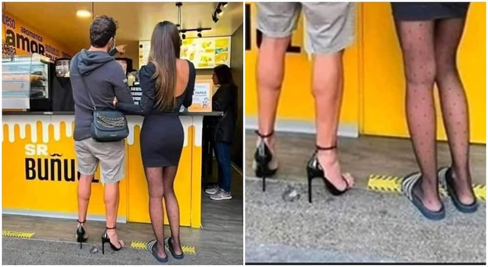 Photo of man wearing high heels while his woman wears slippers.