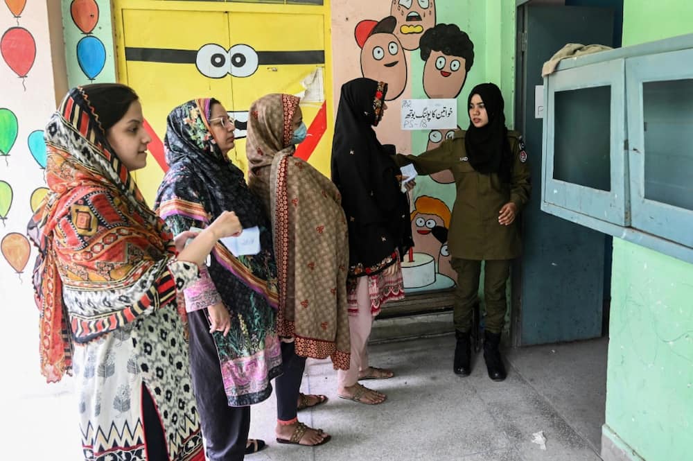 Women line up to cast their ballots in the Punjab province assembly by-election