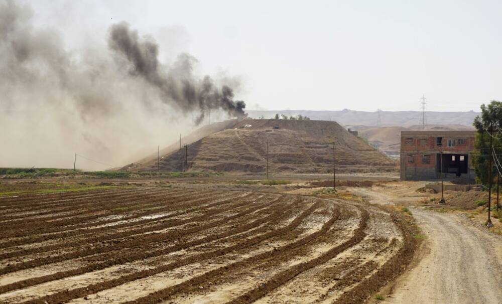 Smoke billows over the village of Altrun Kupri, in the Sherawa region, south of Arbil in Iraq's Kurdistan, where a base of the Kurdistan Freedom Party is located, on September 28, 2022