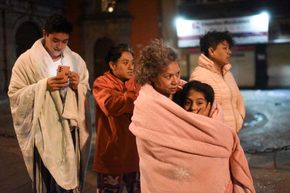 Residents wait in the street in Mexico City after a strong earthquake jolted the capital during the night