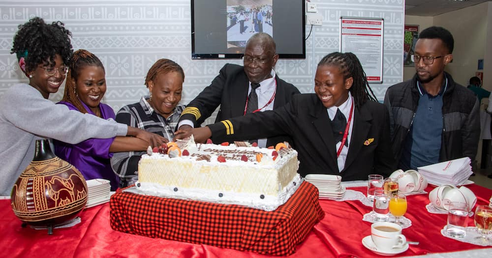 Captain Oteri cutting cake alongside his dear wife and daughter.