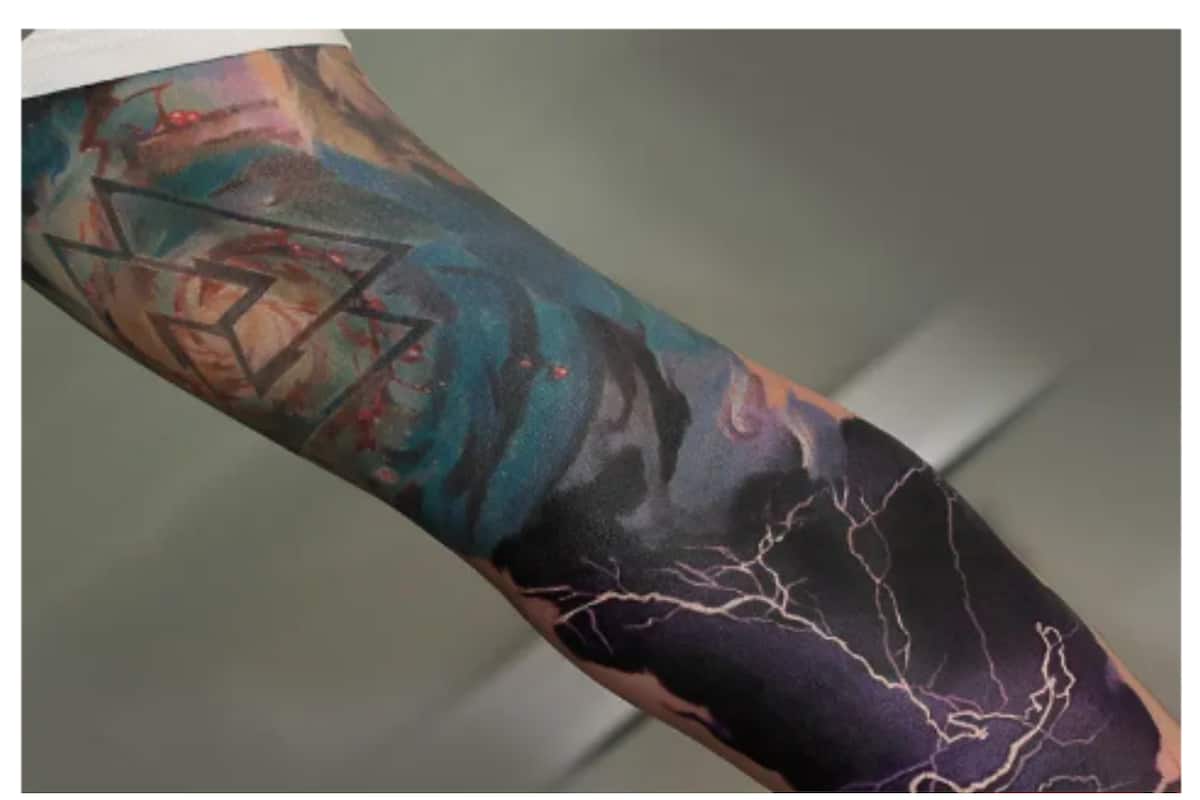 Minimalist lightning bolt tattoo on the inner forearm