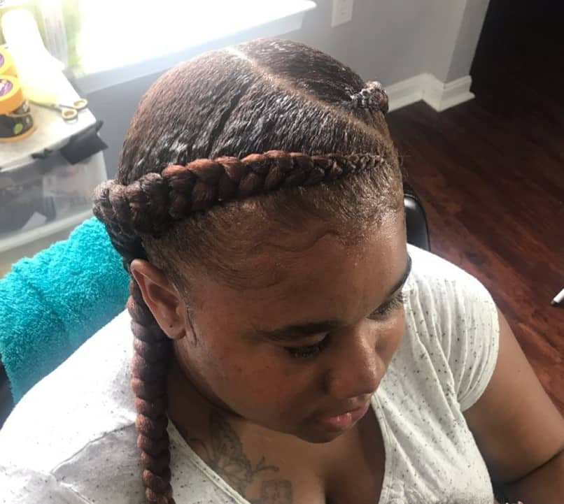 two braids, a haircut close-up of her own hair, details of the hairstyle,  hairdressing art on her head girl Stock Photo | Adobe Stock