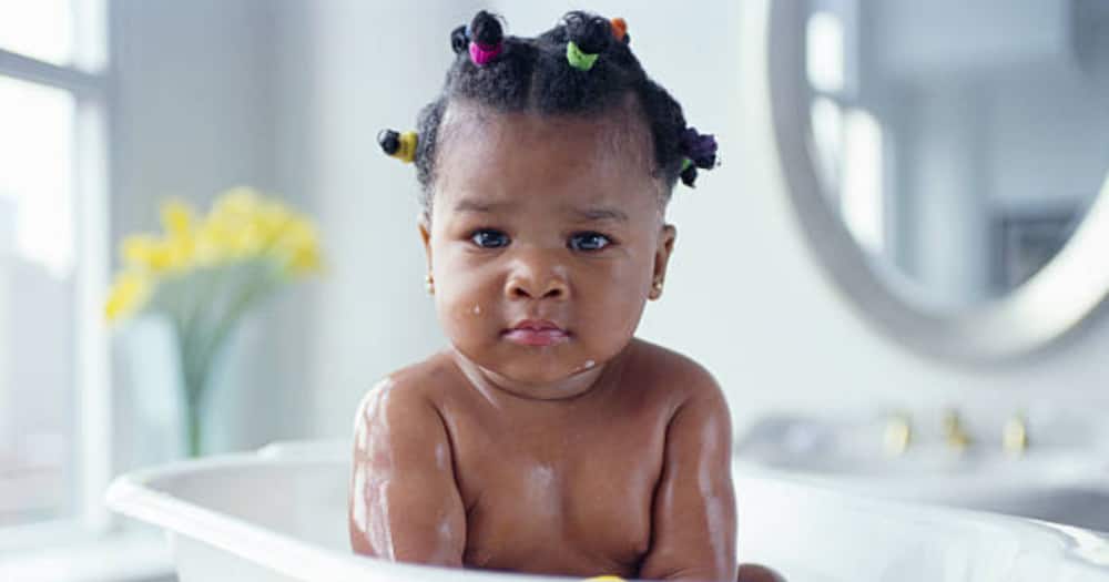 Black girl child taking bath. Photo for illustration.