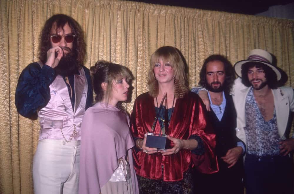 American rock group Fleetwood Mac poses in front of a curtain after winning Favorite Band