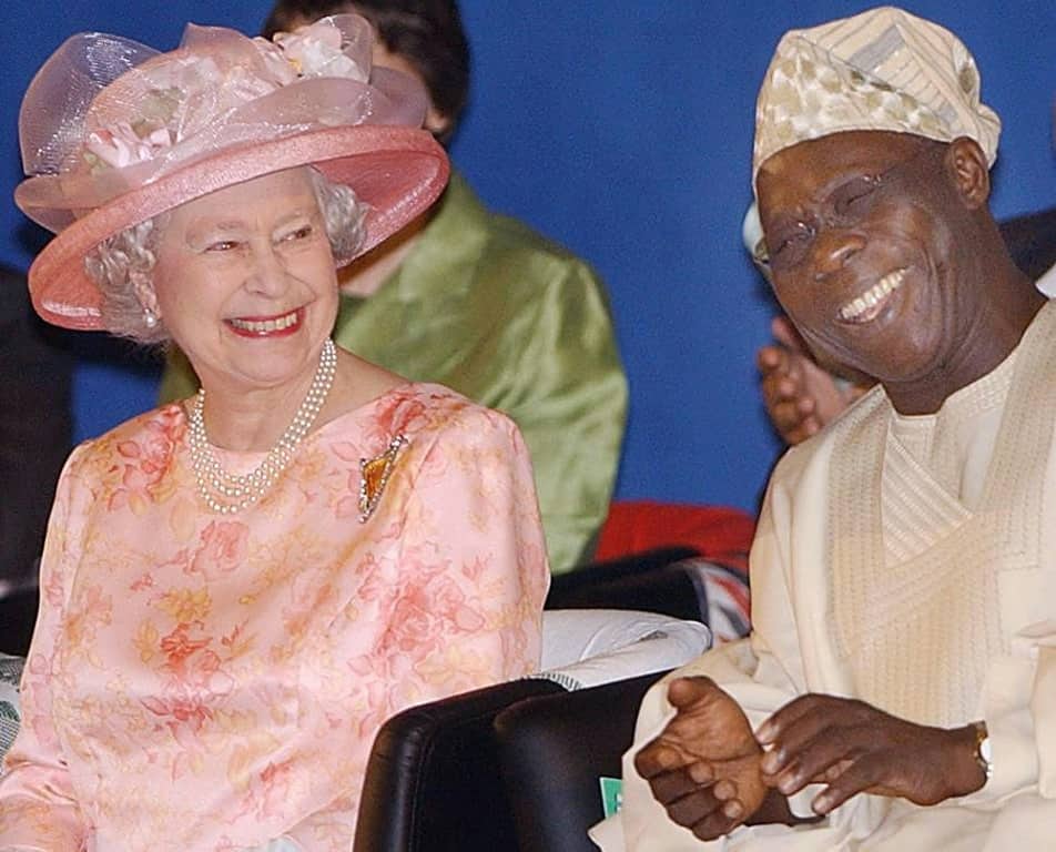 Queen Elizabeth II and former Nigerian president Olusegun Obasanjo smile at the official opening of a 2003 Commonwealth Heads of Government Meeting