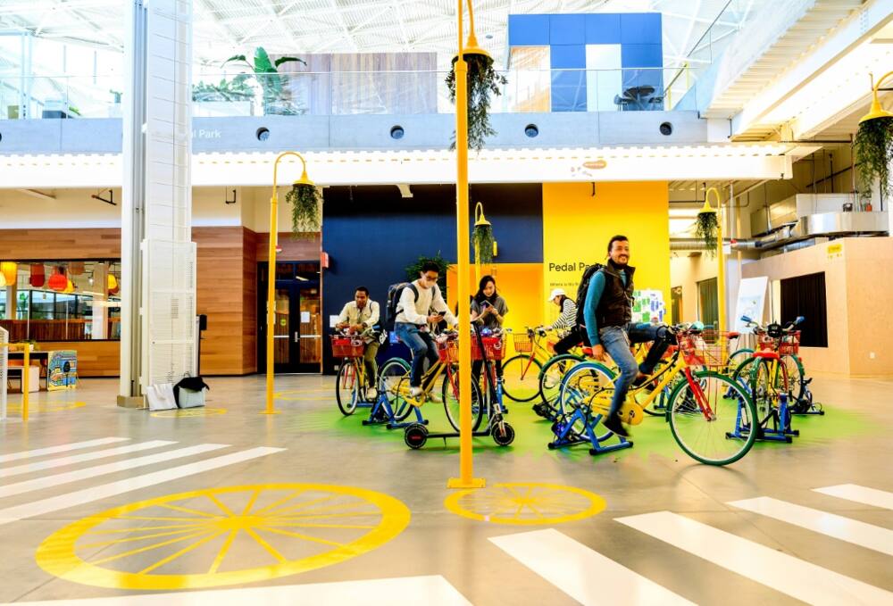 Visitors ride stationary bikes at Google’s Bay View campus in Mountain View, California
