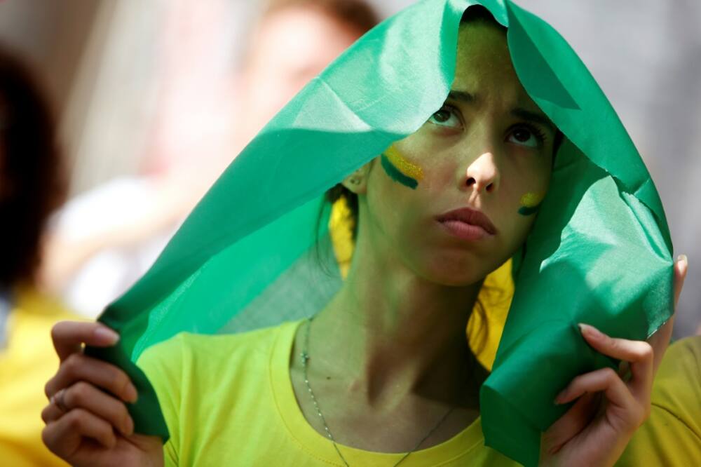 A Brazil fan watches the broadcast of the Qatar 2022 World Cup Group G football match between Brazil and Serbia at the FIFA Fan Festival, in Vale do Anhangabau, Sao Paulo, Brazil, on November 24, 2022