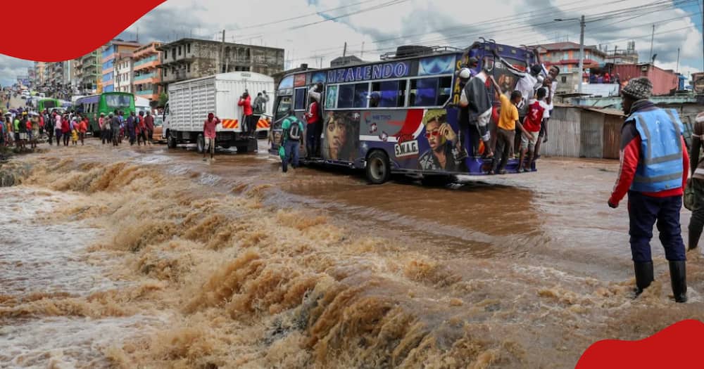 Pedestrians crossing a flooded section of a road in Nairobi.