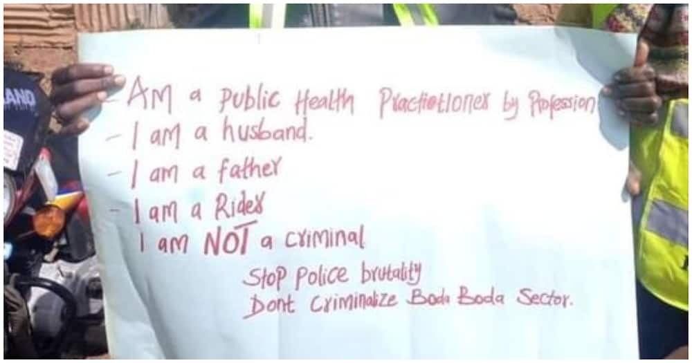"I'm a Husband": Boda Boda Rider Holding Placard Pleads with Govt Not to Criminalise Them