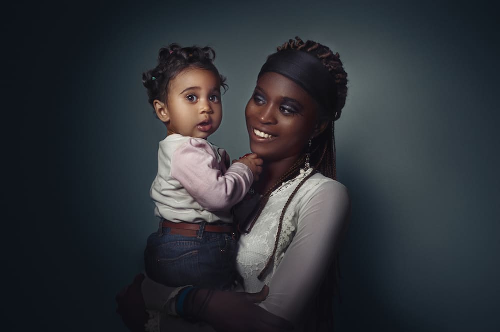 A woman is holding her baby