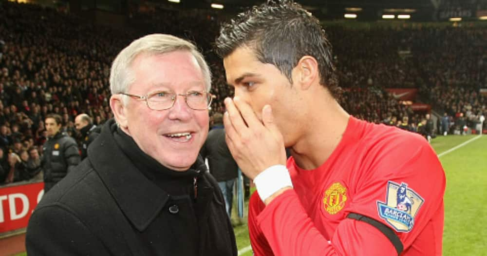 Sir Alex Ferguson of Manchester United presents Cristiano Ronaldo with his FIFA World Player of the Year award ahead.(Photo by John Peters/Manchester United via Getty Images)