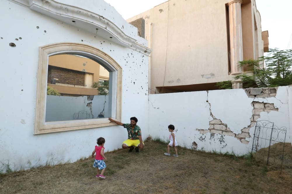 One of the walls of Aguil's house is riddled with bullet holes, bearing witness to the violence that has repeatedly ravaged the North African country