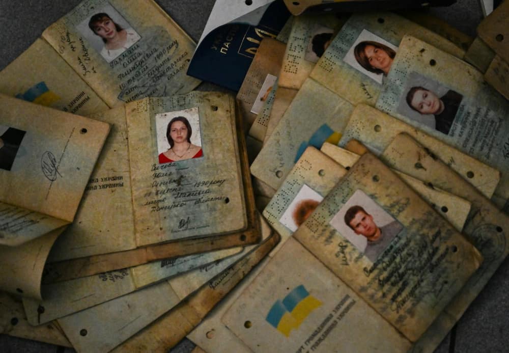 Ukrainian investigators are going through a pile of passports found in the ruins of Izyum police station