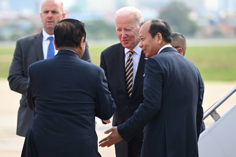 US President Joe Biden (C) is greeted by Cambodian officials after arriving in Phnom Penh on Saturday for an ASEAN summit