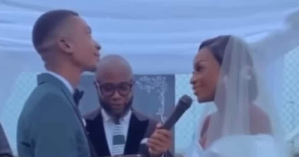 Man sheds tears during vow exchange with wife.