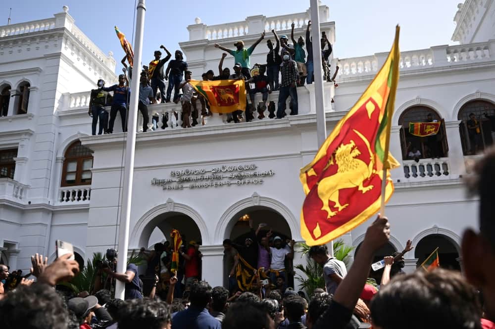 Some of the civilians sang or waved the Sri Lankan flag, with its motif of a golden lion brandishing a sword, after they lobbed back tear gas canisters and pushed past elite commandos on Wednesday to occupy the premises in the capital Colombo