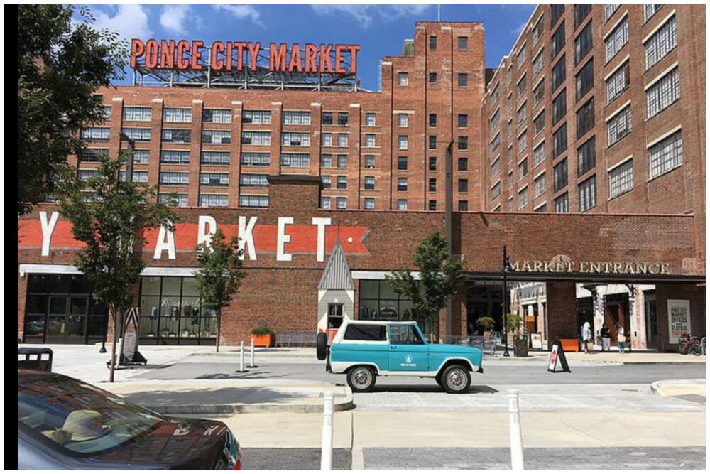 The front of the Ponce City Market showing the large neon sign on the rooftop in Midtown, Atlanta, Georgia.