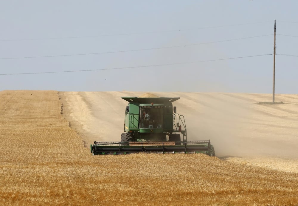A Ukrainian farmer harvests wheat in June near Izmail in far the southwest of the country, in territory still controlled by Kyiv.
