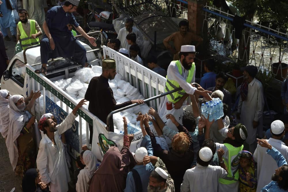 Drinking water being distributed for flood displaced people at a camp in Nowshera, Pakistan
